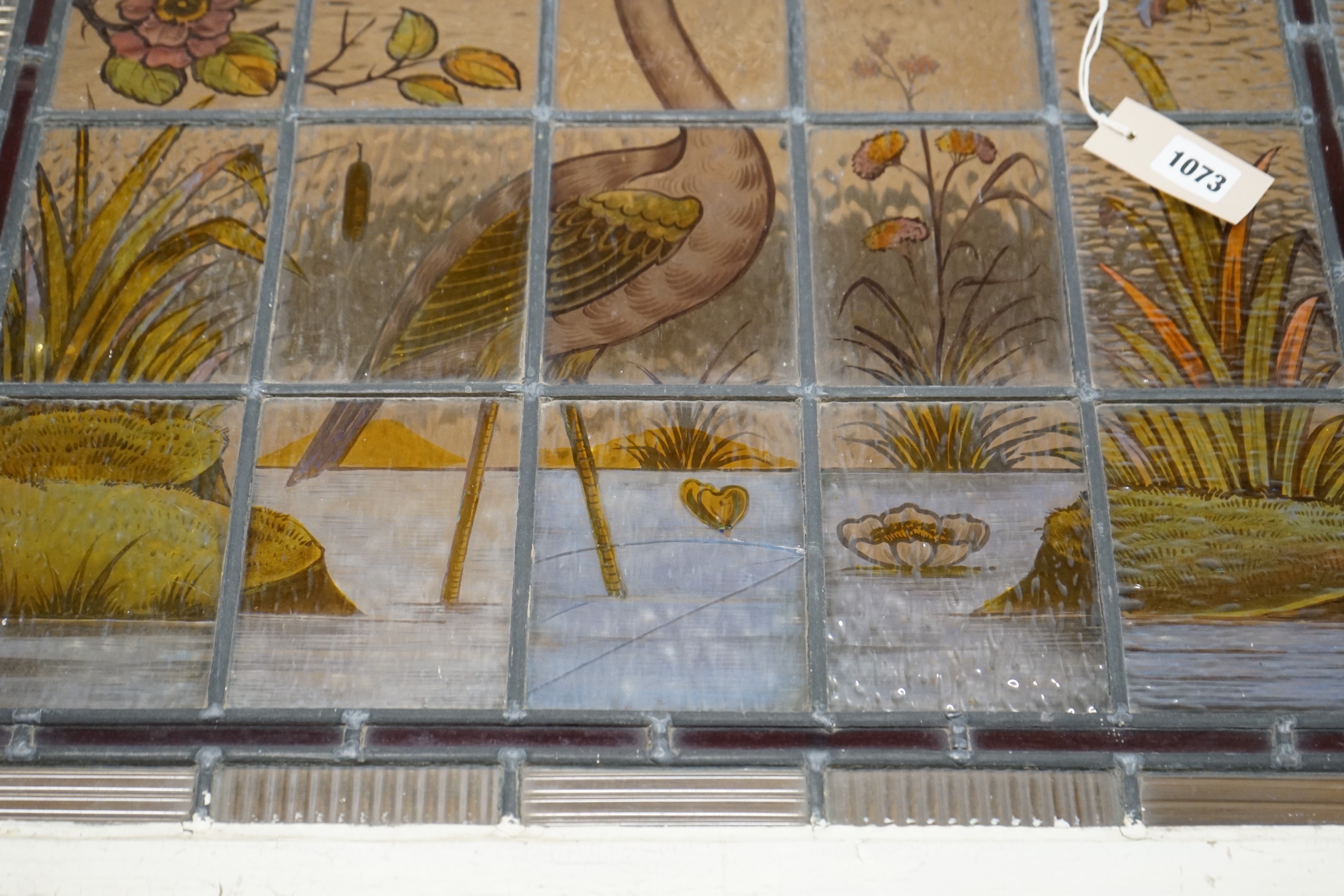 A late Victorian stained leaded glass panel depicting a heron amongst reeds, width 71cm, height 61cm